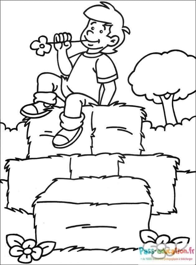 Coloriage Garçon sur ballots à imprimer et colorier